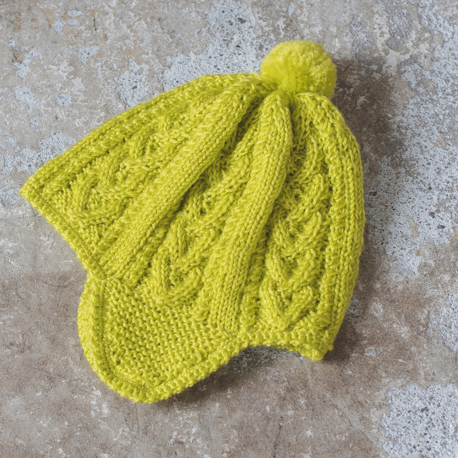 Knitting pattern for Aran patterned baby hat with earmuffs (12-24 months)